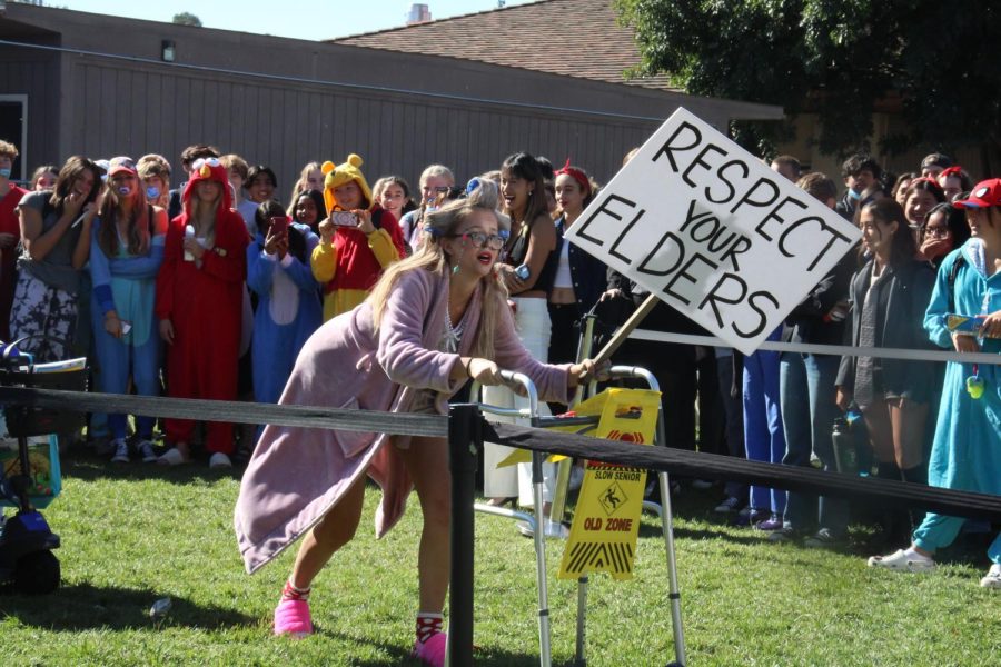 Senior Lily Deandre, dressed as a senior citizen, slowly hobbles down the catwalk as she supports herself with a walker during the best-dressed competition Thursday brunch at the quad.