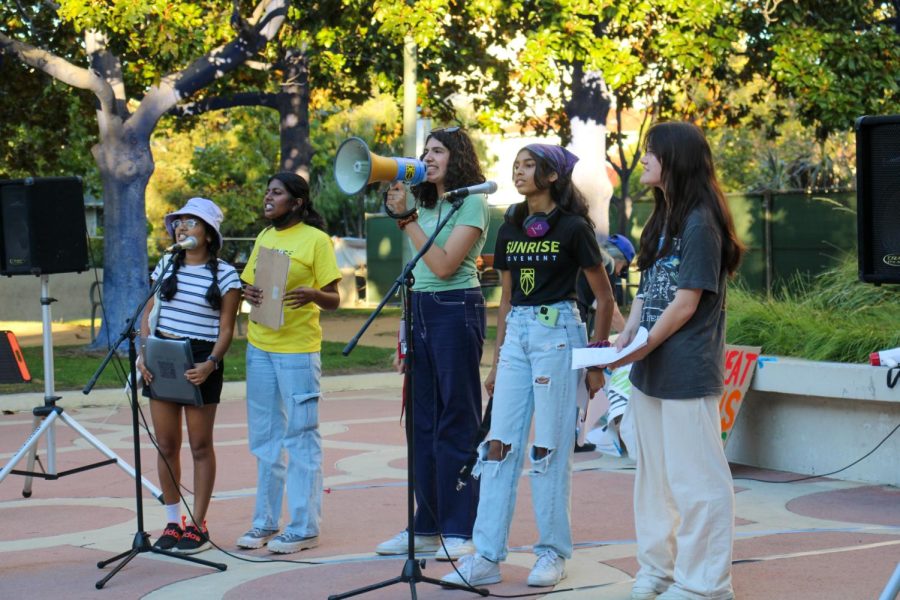 Youth activists from Palo Alto Student Climate Coalition, the Sunrise Movement, and more line up to speak to the crowd during the Global Climate Strike, a string of international anti-climate change protests led by Fridays for Future. The protest took place Friday evening in Hamilton Plaza. Sanjana Sathishkumar, second to the left and a senior at Evergreen Valley High School, was one of the speakers representing the Sunrise Movement. Our focus is to spread intersectionality and advocacy for climate justice in this area, Sathishkumar said. (Photo: Anna Feng) 
