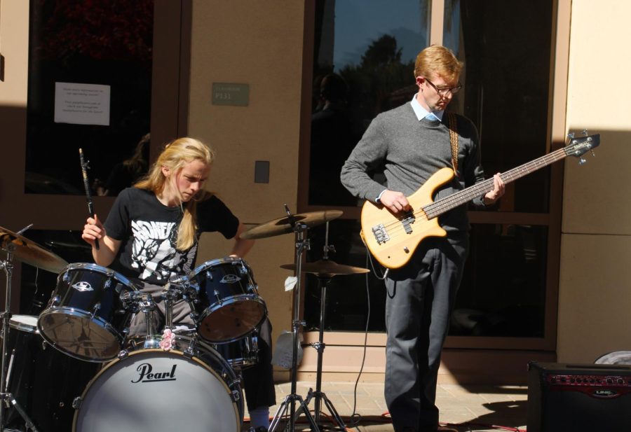 Kyle Vetter and Zachary Barnes, members of the band Pascal’s Triangle, perform at the Associated Student Body’s Spook-Side lands event hosted during lunch Thursday at Centennial Plaza. The group was formed the weekend before the event when Vetter asked Barnes to perform. Barnes said the community generated from events like Spook-Side lands is gratifying to witness. “I think its so singular that Paly has opportunities to do this,” Barnes said. “I think most people are kind of separated and see everybody mix it up with like productive ways to spend your time its really awesome.”
