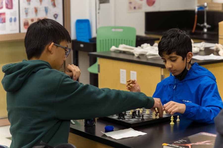 Underclassmen Austin Mei (left) and Ashwin Rajan (right) face off in a game of chess during Chess Club Monday in Room 1107. The game has been rising in popularity for a year, gaining traction among students as an in-class hobby. Sophomore International Chess Federation (FIDE) Master Austin Mei attributes it to the pandemic.[Chess] gained a lot of attention in the pandemic, when everyone was on their computers, Mei said. It hooked a lot of people, and I dont think its too much of a problem if youre playing in class and learning well regardless. (Photo: Evan Chien)