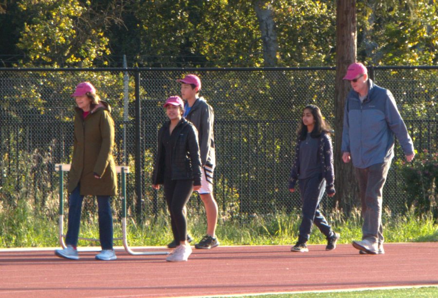 A group of students and staff amble down the track as part of the Power Moves walking club on Monday mornings at Palo Alto High School. According to Power Moves founder Lucy Filppu, the hope is to encourage more people to join the club with motive of helping L.A. fire victims. “This[fundraiser] is the right thing to do," Filppu said. 
“We’re hoping this is a really nice way to get the Power Moves’ name out there on the Paly campus, so more kids want to join us on the track,” Filppu said. “Regardless of fundraising, just to walk on Mondays at 8 and chill out without competition. It’s a great way to get people more aware of Power Moves.” 