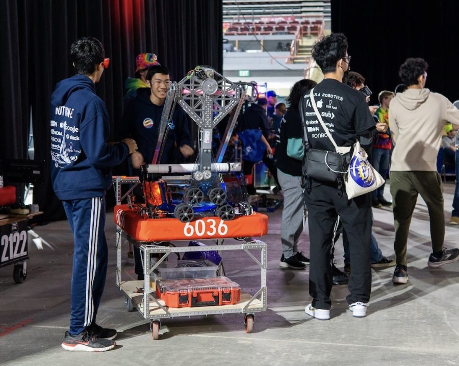Peninsula+Robotics+team+members+wheel+their+robot+into+the+loading+zone+prior+to+a+match+during+the+Idaho+Regional.+Although+the+team+won+the+regional%2C+they+had+already+secured+a+bid+a+week+earlier+at+the+Arizona+East+Regional+to+go+to+the+FIRST+Robotics+World+Championships.+According+to+software+captain+Ashray+Gupta%2C+a+challenging+part+of+build+season+was+ensuring+involvement+from+every+individual+team+member.+%E2%80%9CPart+of+build+season+was+figuring+out+how+to+organize+people%2C+how+to+get+people+engaged%2C+how+to+involve+as+many+people+as+possible+in+like+the+stuff+that+we+have+to+offer%2C%E2%80%9D+Gupta+said.+%E2%80%9CWe+pride+ourselves+in+being+an+open-door+team%2C+where+anyone+can+do+whatever+theyd+like+in+STEM.%E2%80%9D+%28Photo%3A+Ethan+Sa%29