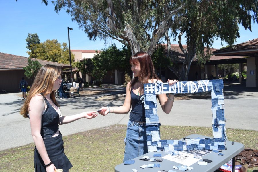 Junior and co-president and junior Bella Nguyen (right) hands a denim patch to junior Ellie Roth (left) during lunch on the Quad today as a part of this year’s Responsive Inclusive Safe Environment Club National Denim Day. According to Nguyen, the national day began through a movement to prevent victim blaming in sexual assault cases. “This day is supposed to hold power,” Nguyen said. “This day carries weight by spreading awareness and advocating against sexual assault by wearing denim and we encourage all students to do so.” (Photo: Celina Lee)