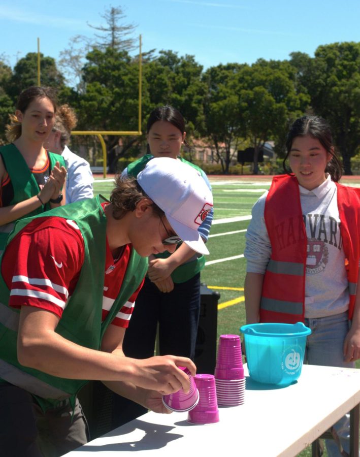 Sophomore Briar Dorogusker (left) cheers on her sophomore team during the cup-stacking section of the relay race today during lunch at the Viking Stadium, one of several of this week’s Spring Spirit events. Dorogusker said she loved seeing the excitement during the events and being able to bond with her peers. “I really enjoyed the race and hearing the music and chatting with people,” Dorogusker said. “It was super fun because I talked to people who I had never talked to [before].” (Photo: Kristine Lin)