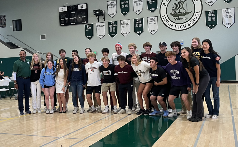 Palo+Alto+High+School+coaches+and+senior+athletes+gather+for+a+photo+following+committing+to+their+college+of+choice+for+sports+during+Signing+Day+on+Thursday+at+the+Peery+Family+Center.+According+to+senior+Julian+Galinda+Macias%2C+it+was+especially+satisfying+to+see+the+accumulation+of+all+his+effort+build+up+over+the+past+years.+%E2%80%9CSeeing+all+my+work+pay+off+at+the+end+was+rewarding%2C+especially+because+there+were+a+lot+of+times+that+my+work+wouldnt+show+off+in+my+results%2C%E2%80%9D++Macias+said.+%E2%80%9CIt+was+nice%2C+just+being+able+to%2C+especially+this+last+season%2C+play+at+the+level+that+I+shouldnt+be+playing+and+have+and+create+bonds+with+my+teammates+at+Paly+as+well.%E2%80%9D+%28Photo%3A+Ketan+Altekar-Okazaki%29