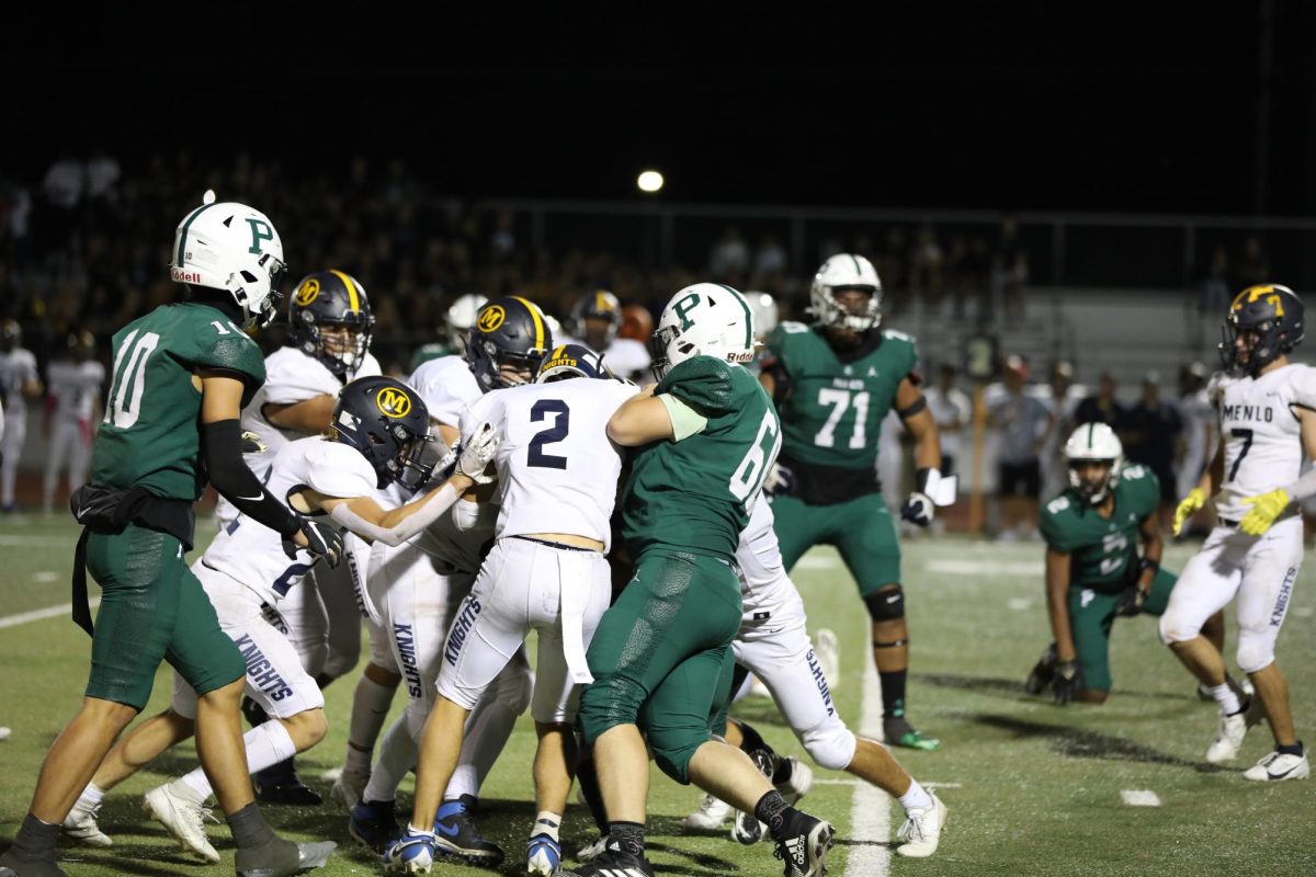The Menlo School Knights push the pile against the Palo Alto High School Vikings during the Homecoming match on Friday night at home. The Vikings suffered a 0-14 loss following a fourth quarter surge by the Knights. According to Viking senior running back Jeremiah Madrigal, the Vikings need to work on perfecting their offensive plays. We have to start from the base, Madrigal said. Its on offense. We have to figure out our blocking on the line and figure out our routes. Everybody has to do their work, come to practice and just keep working. (Photo: Divij Motwani)