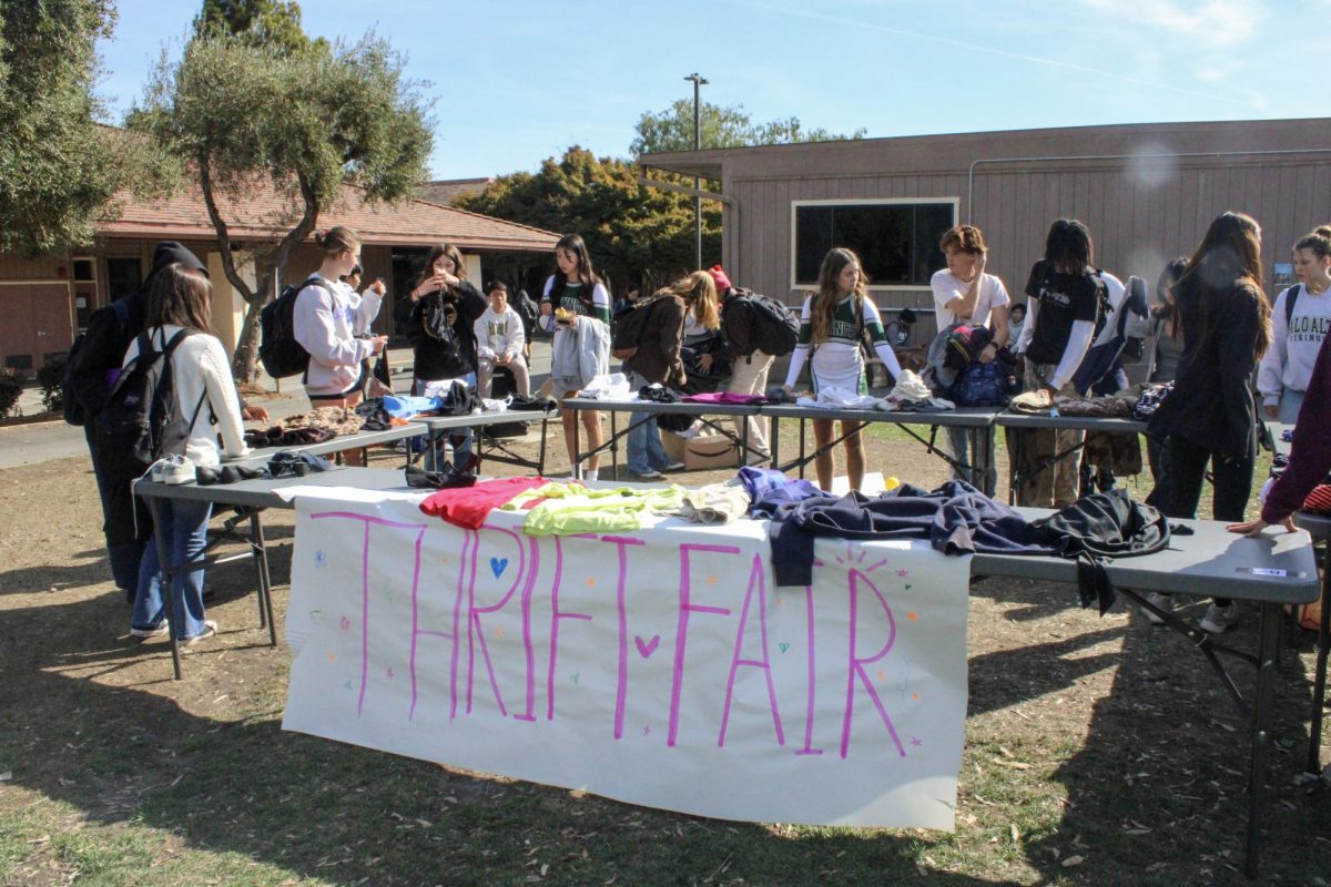 Palo Alto High School students sift through items of clothing at Paly’s first thrift fair, which took place during lunch yesterday on the Quad. According to organizer and sophomore class senator Simone Batra, she was pleased with the student participation in the fair. “I was a little bit nervous for this event, but it went really well,” Batra said. “A lot of people really enjoyed thrifting, especially since the clothes were free.” (Photo: Kristine Lin)