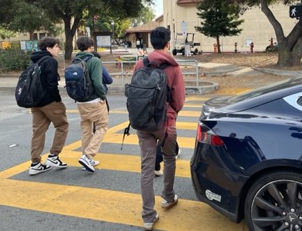 Students walk across the intersection between Palo Alto High School and Town & Country Village during lunch. The district plans to implement the Safe Routes to School program in secondary schools to promote biking and walking safety. According to Assistant Principal Jerry Berkson, students don’t only need to be worried about themselves, but also their surroundings. “Students should be more aware of their surroundings and know that just because theyre doing the right thing, doesnt mean the person who is driving is doing the right thing,” Berkson said. “So be very defensive, like, while youre being a defensive driver.” (Photo: Ketan Altekar-Okazaki)