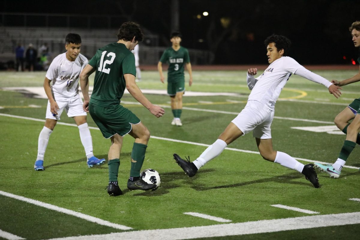 Palo Alto High School Viking senior right back Dominic Profit keeps the ball away from a Santa Clara High School Bruins defender during the boy’s varsity soccer game on Thursday. The Vikings defeated the Bruins, 2-0, for their first league victory, giving them a chance to qualify for the CCS at the end of the league. According to Viking head coach David Light, there is a lot to be hopeful about for the Vikings in the near future. “We had a lot of passion, a lot of hard work, a lot of fun, and a lot of unity in the game,” Light said. “It seems like theres a lot of love between our players here, so thats good.” (Photo: Ketan Altekar-Okazaki)