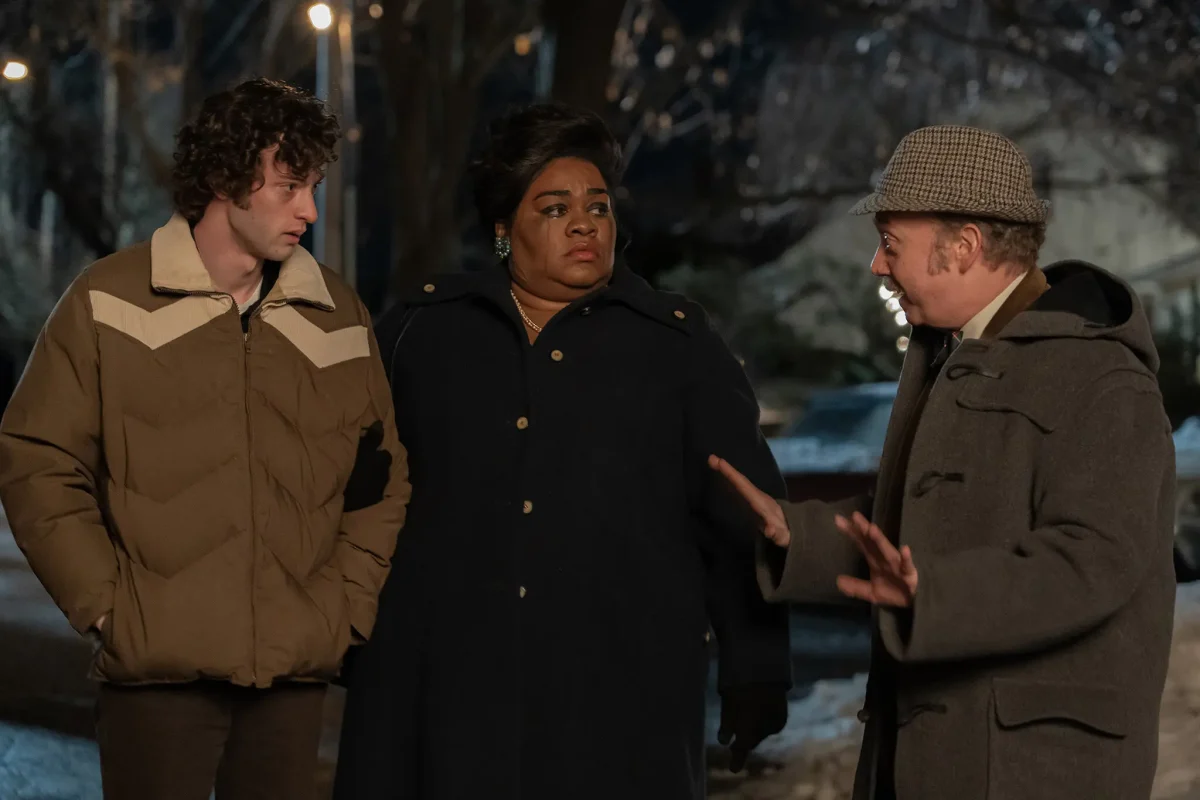 Paul Hunham (Paul Giamatti), Mary Lamb (DaVine Joy Randolph) and Angus Tully (Dominic Sessa) stand in the cold after leaving a Christmas party in The Holdovers. (Photo: Seacia Pavao)