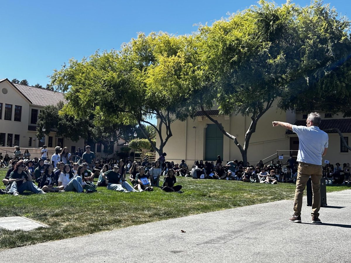 Principal Brent Kline speaks Tuesday afternoon to freshmen and other new students at orientation on the Quad at Palo Alto High School. Kline set expectations for the culture at Paly. "We hope you take advantage and ask questions of our upperclassmen who put this together and that you follow our values of learn, connect and respect," Kline said.