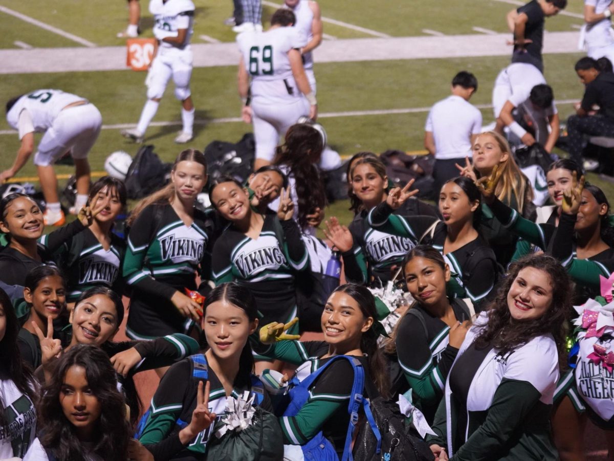 The Palo Alto Cheer Team celebrates after a victory at an away-football game. On the right, new cheer coach Helene Gurewitz flashes a smile and encourages her team to put up victory signs. According to Gurewitz, she looks forward to applying her experience in leading the team to additional victories. “I’ve been a cheerleader since I was a freshman in high school, so almost 10 years ago," Gurewitz said. "Then I moved on to cheer in college at Berkeley, and now I am currently a part of Cheer San Francisco. We’re a charitable cheer organization in the Bay Area.”