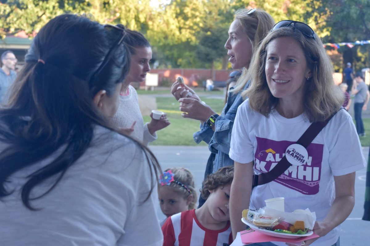 Alison Kamhi chats with a fellow parent on Friday at Escondido Elementary School’s International Night. According to Kamhi, she has connections to teachers in the district and wants them to feel heard. “I am very proud to be endorsed by the teachers' union so having kids in the district for many years has allowed me to also form those relationships with teachers,” Kamhi said. “I want to advocate very strongly to make sure that we’re able to retain the great teachers that we have.”