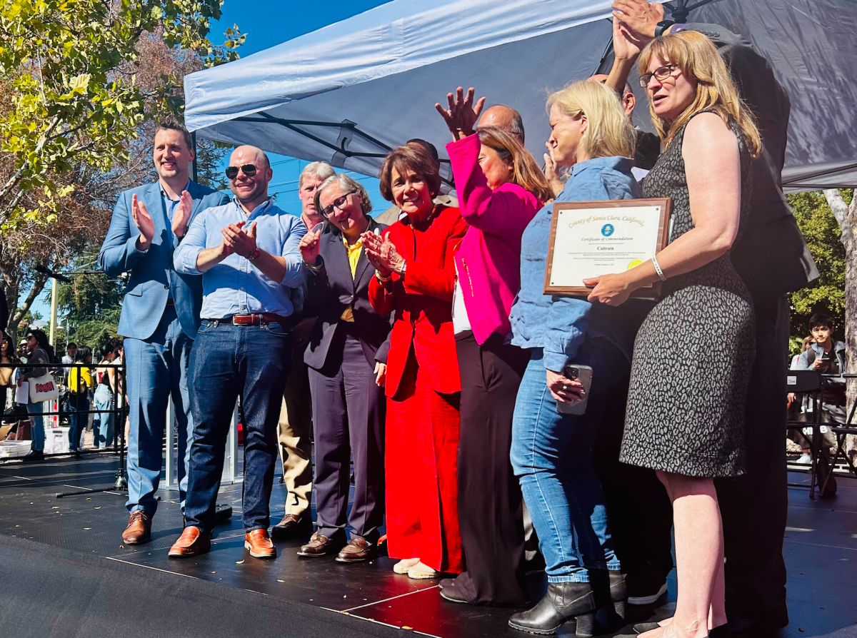 United States Representative Anna Eshoo in red stands with the leaders who made the electric Caltrain possible this weekend at the Palo Alto University train station. According to Eshoo, the team effort was the only way this achievement was possible, "I had to have my colleagues with me; this wouldn't have happened without everyone's support and effort," Eshoo said.