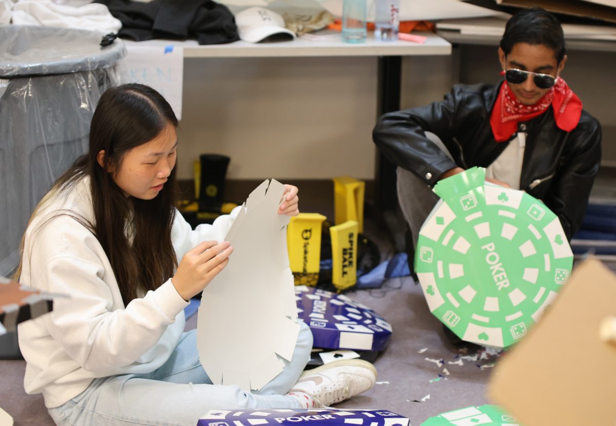 Junior social commissioner Jessica Wong and sophomore senator Aeshaan Singhal create casino-themed decorations during Leadership class. Palo Alto High School is hosting their "Casino Night" themed Homecoming dance at 7 p.m. on Saturday at the Centennial Plaza. According to Wong, the theme for the upcoming dance perfectly accommodated the location. “We chose the casino theme because we thought it was a great option to incorporate indoor and outdoor sections of the dance.”