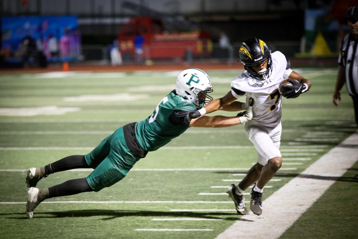 Viking senior running back Isaiah Philips pushes Charger senior wide receiver Semaj Clark out of bounds during the Homecoming match on Friday at home. The Vikings suffered a 13-42 loss following a second-half surge from the Chargers. According to Viking senior Joseph Kessler their loss was due to not taking enough risks. “We didn’t make the big plays that we wanted to tonight, and that’s the difference in the game,” Kessler said. “They did. We didn’t.” (Photo: Arjun Jindal)