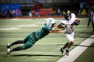 Viking senior running back Isaiah Philips pushes Charger senior wide receiver Semaj Clark out of bounds during the Homecoming match on Friday at home. The Vikings suffered a 13-42 loss following a second-half surge from the Chargers. According to Viking senior Joseph Kessler their loss was due to not taking enough risks. “We didn’t make the big plays that we wanted to tonight, and that’s the difference in the game,” Kessler said. “They did. We didn’t.” (Photo: Arjun Jindal)