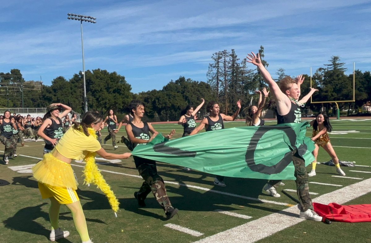 Following the senior class dance, the Class of 2025 rushes towards the bleachers, running through their green sign. Sophomore Kane Do commended the seniors performance. "They did really well and I hope they have a nice farewell," Do said.