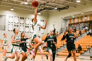 Viking freshman guard Abigail Neumann scores a layup against the James Lick Comets during the first quarter of the game at Palo Alto high school. According to Neumann, offensive consistency was paramount to the Viking's victory. "We ran our plays all the way through, and were really consistent on offense, scoring throughout the entirety of the game," Neumann said.