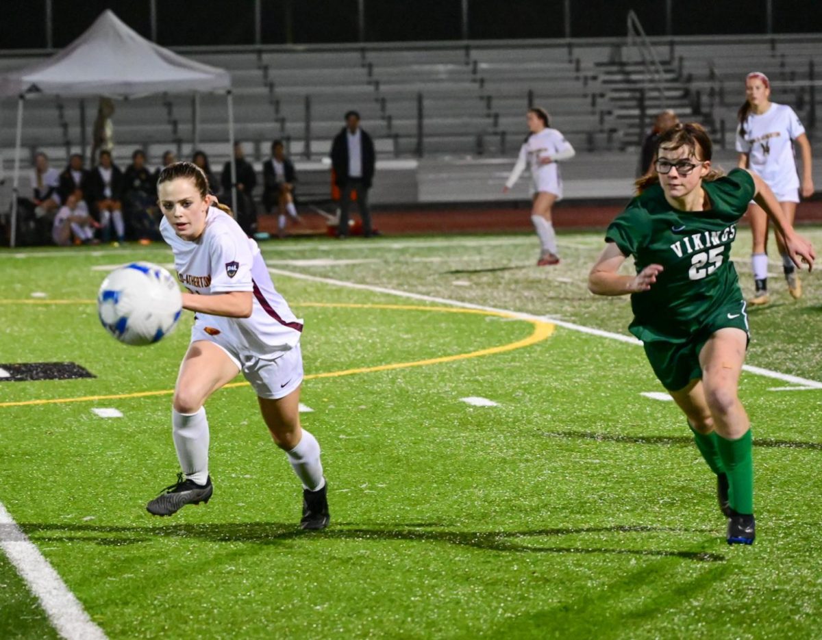 Viking junior Cassie Gracon chases down a ball against a Bear midfielder Thursday night at Palo Alto High School. The fast-paced game ending in 2-2 tie marked an improvement from their early season loss for the Vikings. Vikings’ head coach Jeremy Romero said they had much ambition for the season. "Our goals in the league is to win it. To win it."