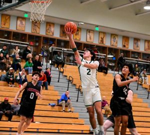 Viking sophomore Justin Fung scores a layup in the final quarter of the game against the Fremont Firebirds at Palo Alto High School on Monday. According to Fung, the Vikings were hyped to play this game. "I think the mindset coming this game was must win game," Fung said. "I think our energy has been a little low throughout practice, but I think coming in this game on pregame, vibes were really high."