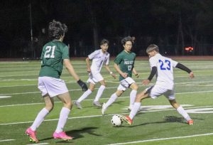 Palo Alto High School Junior James Park and Senior Lucas Yuan defends against Santa Teresa Saints midfielder. The fast-paced victory 4-0 win at home on Dec 6 continued the Viking's undefeated record. According to Paly Coach Luiz Lodino, "They're here before seven in the morning, before we start, because that's the time that we train." 