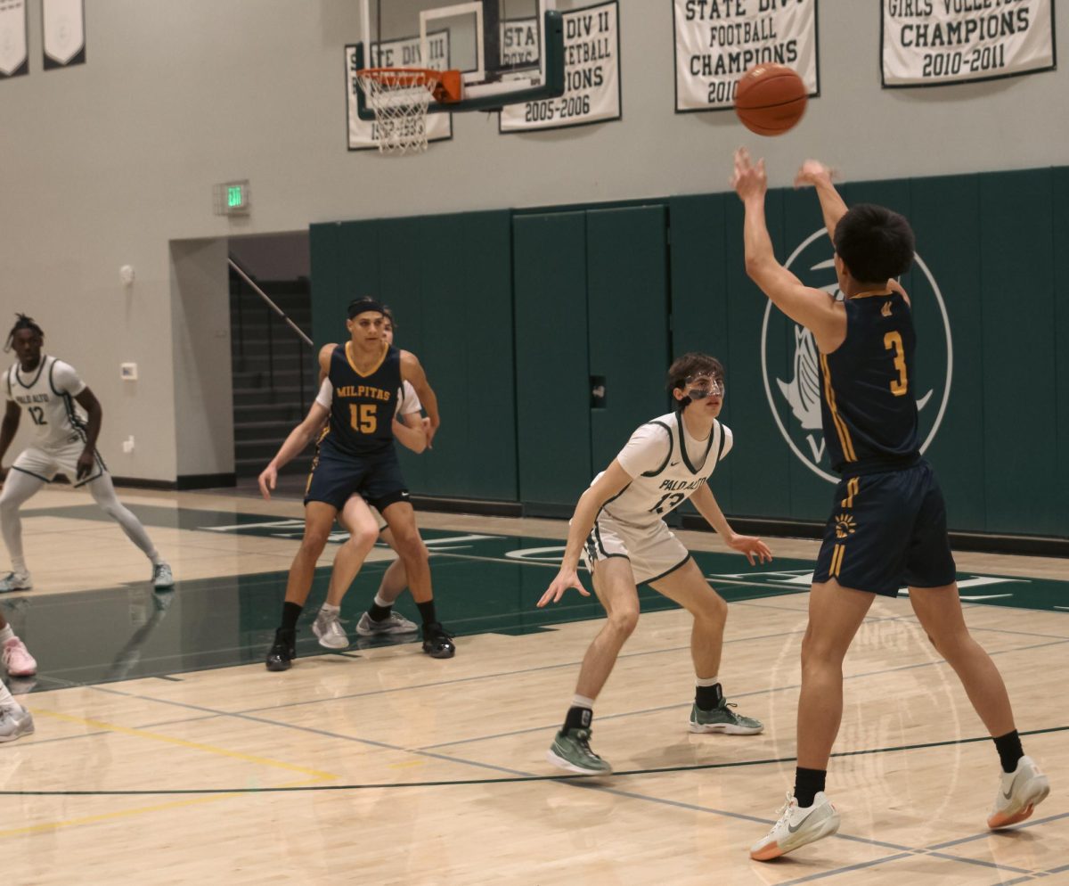 Trojan junior Dylan Nguyen shoots the ball.