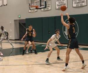 Boys' basketball first in league after defeating Trojans