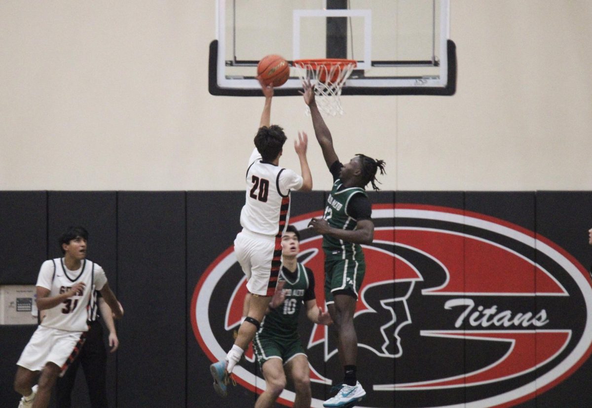 Viking senior Jorell Clark sets up a block in a rivalry game against the Gunn Titans at Gunn High School on Saturday.  According to Gunn assistant coach Sky Runser, despite losing the game it was a worthwhile experience. "It was a great rivalry," Runser said. "It's fantastic to watch the players play against people they played with and against all throughout their childhood. They all know one another and the crowd is fantastic."