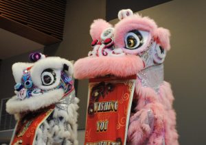 Two lion dancers unveil auspicious tapestry at the Lunar New Year Celebration at Palo Alto's Mitchell Park Community Center. According to Palo Alto resident Yi Chen, the event was both fun and enriching for his family. “This is my first time at a Lunar New Year event in Palo Alto,” Chen said. “I think this event is pretty great as it shows all ages what Asian culture is as well as its traditional art forms.”