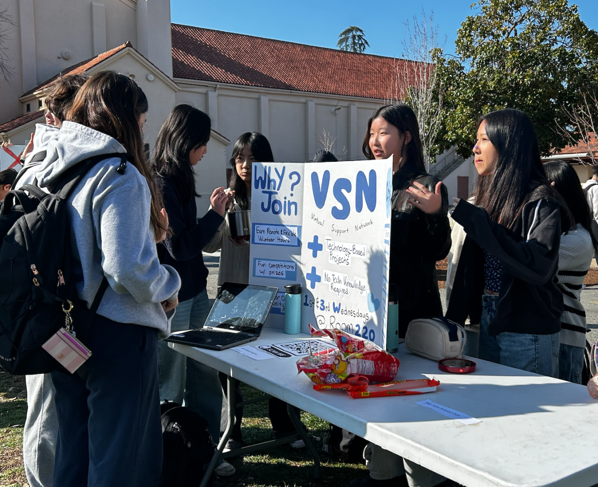 Students engage with The Virtual Social Network Club booth during Spring Club day Friday at lunch on the Quad. According to sophomore and President of VSN Jasmine Kwak, this club has big goals for its members. "Our goal is to make it so that there's a project that you need to do and turn in for service hours so you can help the community without feeling too stressed," Kwak said.