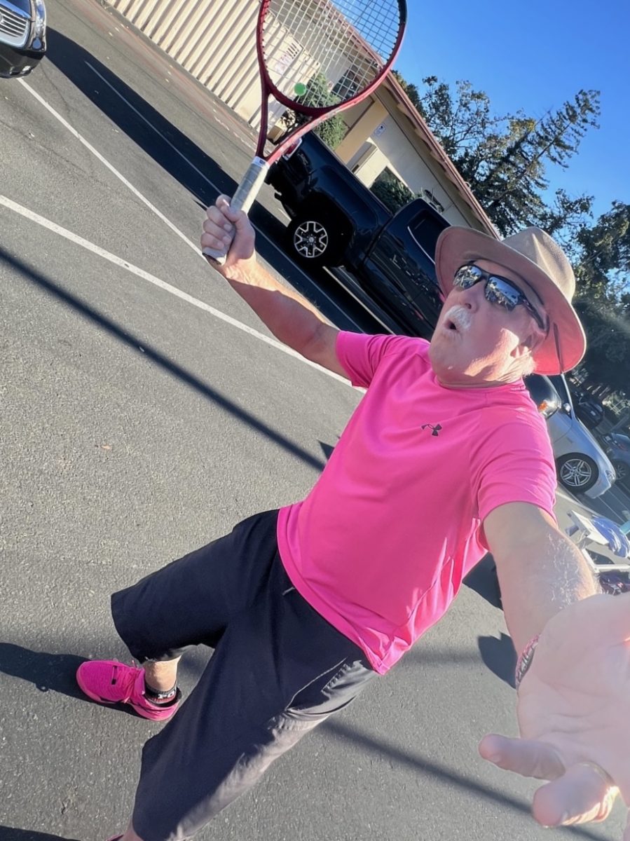 Former head coach Andy Harader poses with his pink spirited outfit outside the Palo Alto High School tennis courts. According to Harader, he is very proud of players implementing his advice. "To see players inspired and utilize techniques I drilled into them is very gratifying and has given me a sense of pride," Harader said.