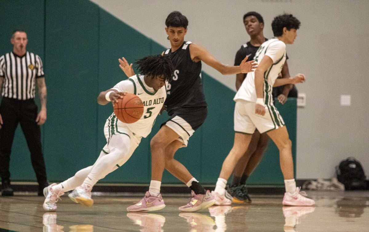 Viking senior Isaiah Phillips pushes past Cougar defender in the first round of the Central Coast Sectionals Tuesday night in a home game against the Evergreen Valley Cougars. According to Viking assistant coach Jim Bitler, the team's success is driven by their dedication and unity. "The kids that we have at this basketball program [and] their willingness to sacrifice and compete at a real high level and come together as a team," Bitler said. "It’s been really special to watch."