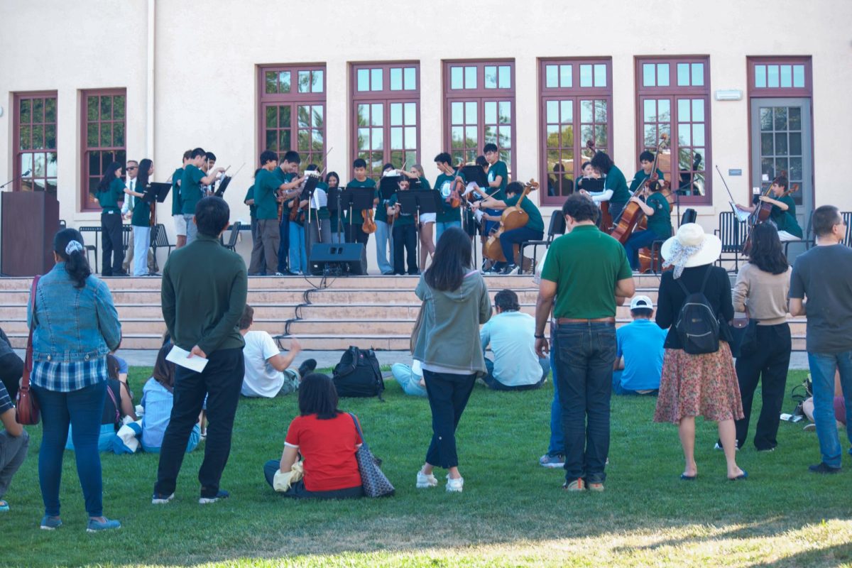 The Palo Alto High School orchestra plays in front of the Tower Building Thursday night at Back-to-School Night. The event draws a crowd of parents on the quad for the parent fair, and to classrooms to meet teachers. According to senior Nusaybah Mohsin, “It felt nostalgic to present something like this," Mohsin said. "It was one of the songs we played when we were freshmen and that was four years ago."