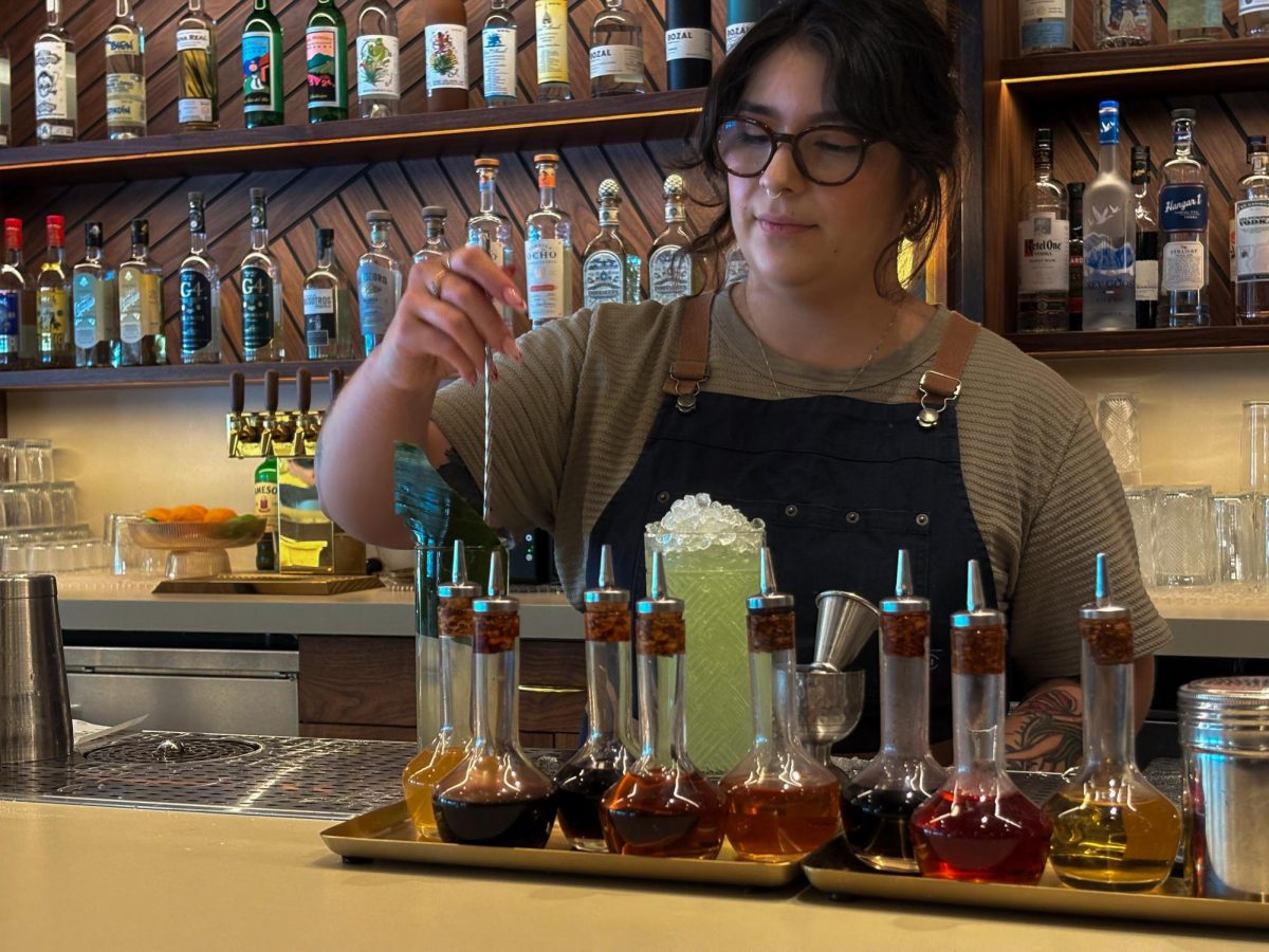 Bartender Juliana Martinez crafts two fruity refreshments. Horsefeather—the latest addition to the Town & Country Village food scene—has an expansive selection of drinks, including mocktails. 
According to Martinez, working since the restaurant's opening has created new experiences for her and other employees. "With a new restaurant, there's a lot of things to think about," Martinez said. "Meeting new people and working in a new space. We [the staff] have all kind of grown as a restaurant together."