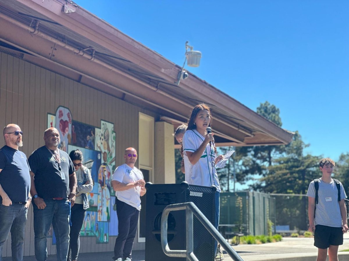 Associated Student Body President Katie Kim gives a welcome speech to the incoming freshmen Wednesday on the Quad at Palo Alto High School. According to Kim, freshmen should branch out beyond their middle school circles and connect with peers from other districts during orientation. “Please be open minded to meeting any new people,” Kim said. “I know there are a lot of Greene, Fletcher and Jane Lathrop Stanford kids, but please be open-minded and meet new people from different districts."