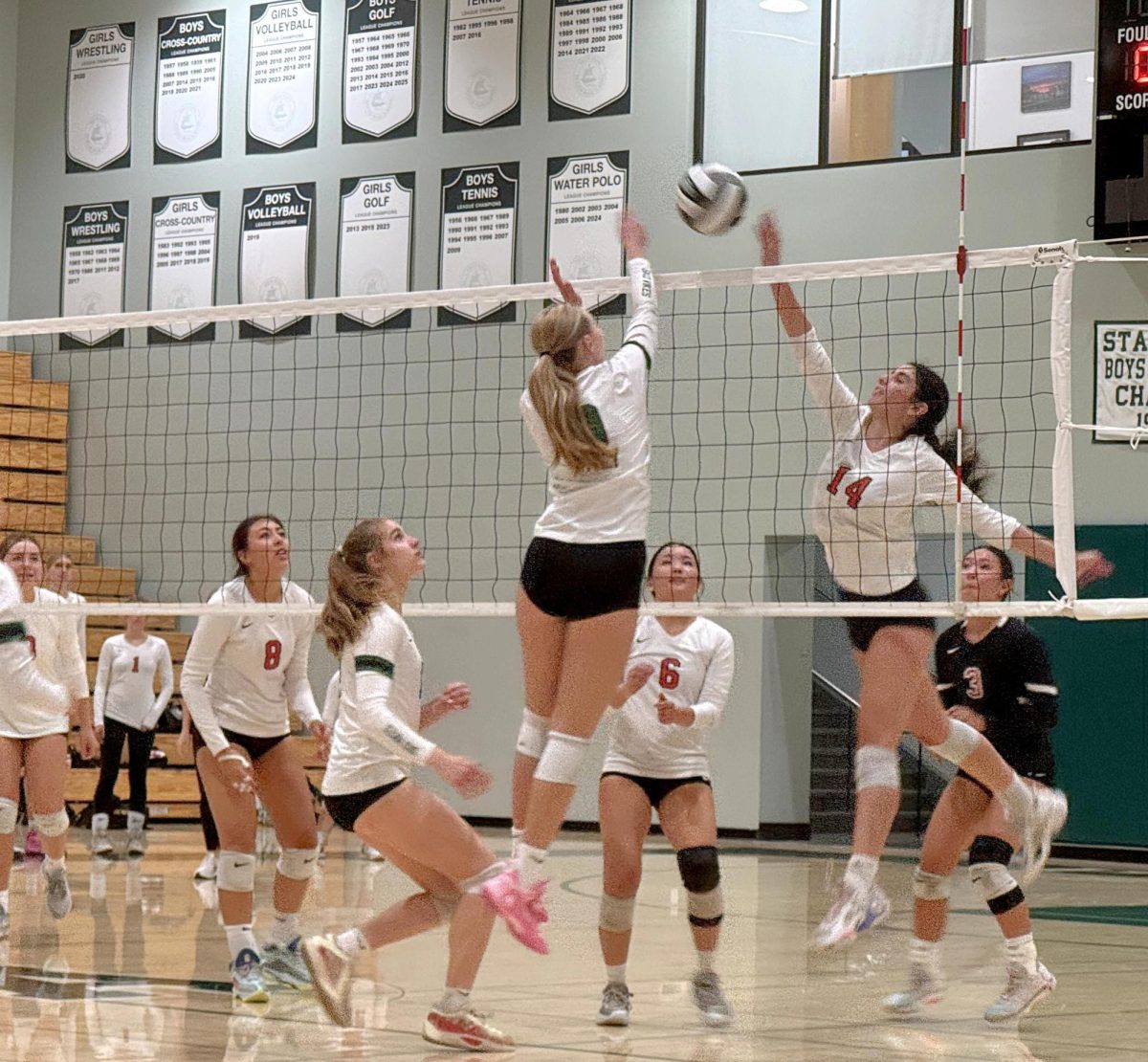 Viking defender blocks a strike from Titan sophomore outside hitter Jessica Jacobson in the final set of the game between the Vikings and the Gunn High School Titans Tuesday night at home. According to Viking head coach Chris Crader, this game was a good opportunity for the newer players to build confidence. "We had a few kids that have come up from JV, so this is their debut," Crader said. "If they can come out and can play Paly versus Gunn, then hopefully that gives them some confidence going forward."