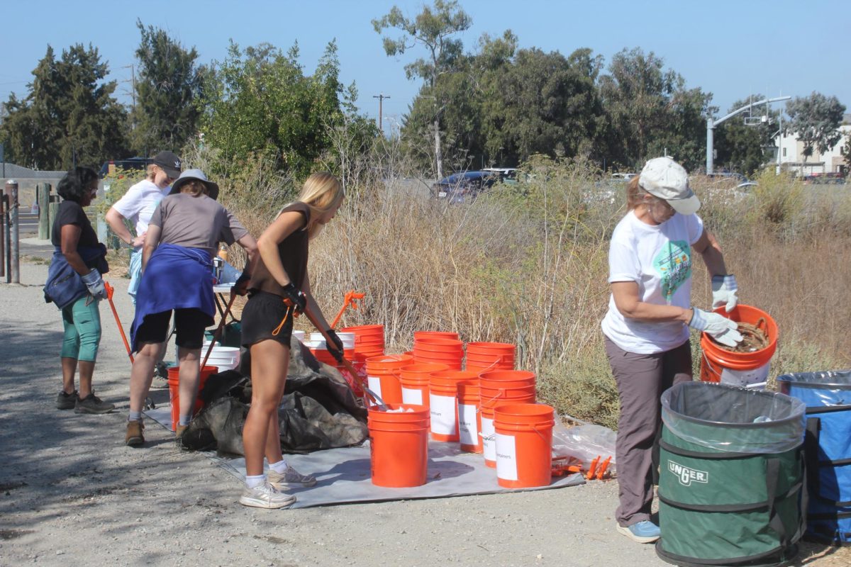 Palo Alto volunteers sort trash collected from Adobe Creek into buckets during Coastal Cleanup Day on Saturday. According to Kirsten Druve, the Palo Alto site coordinator, the Santa Clara Valley Water district removes trash from creeks by providing volunteers with supplies. “The goal is to keep trash out of creeks and the ocean side,” Druve said. “We organize volunteers to come here and we give them supplies so that they can clean the creeks for the morning.”
