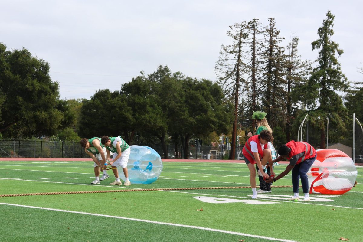Seniors and sophomores go head-to-head in a relay race during the Wednesday Spirit Week rally at lunch on the Palo Alto High School Viking Stadium. According to sophomore participant Jordan Johnsson, he showed his spirit through participating in many class games and enjoyed the interactions between upperclassmen and underclassmen during rallies. "The teams were pretty good and it was a lot of fun to play against the older years and the younger years,” Johnsson said. “I haven't been dressing up that much but I’ve been participating in a lot of the competitions.”