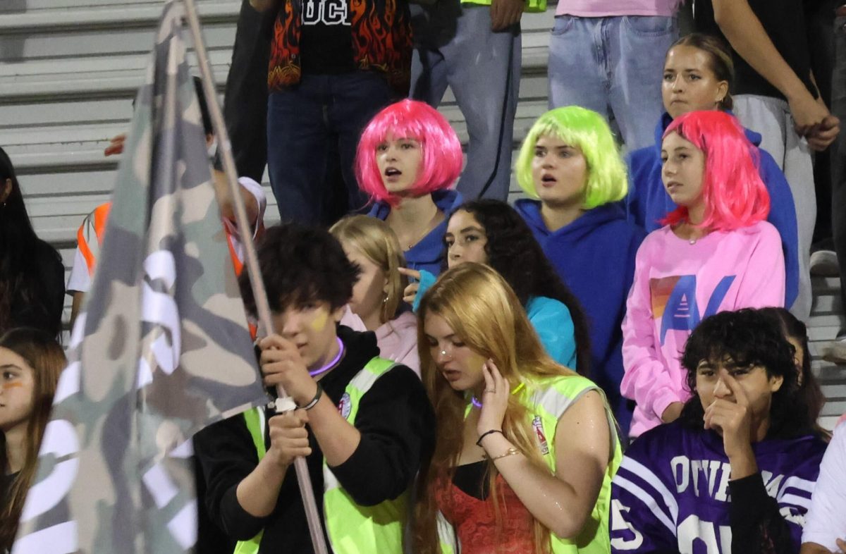 Neon-wearing students gather Wednesday at Palo Alto High School's football field for the annual Spirit Week Night Rally, watching intense competition between grades. According to Associated Student Body President Katie Kim, the best part of hosting the rally is observing students come back to Paly with eager attitudes. "Seeing students come back to school to compete with such spirit is so exciting,” Kim said. 