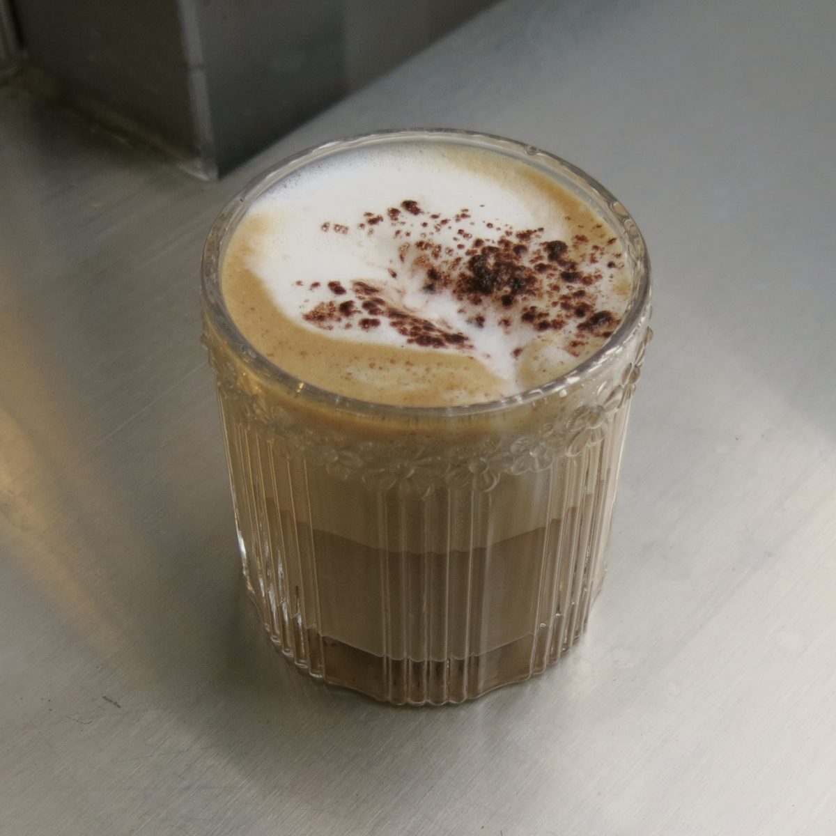 Cappucho — $5.00 — A warm cappuccino, made from equal parts milk, espresso, and foam, topped with chocolate powder.