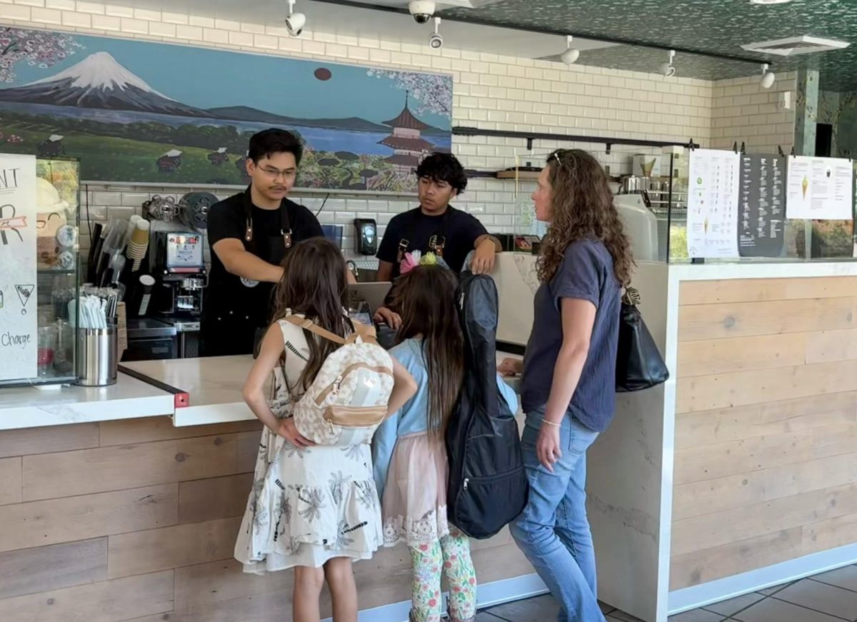Barista Adrian Abastilla takes an order from a family of customers at Ryokucha Cafe on El Camino Real. According to Abastilla, their store won't be heavily affected by the recent matcha shortage. "A lot of the companies that are within these prefectures actually stagger their rotations, and there's way too many suppliers for us to actually not have one," Abastilla said. "Yes, we are behind on shipments, but we are making everything last, and we are rationing very well." 