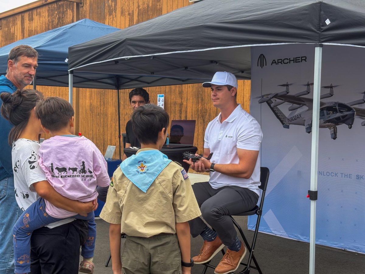 Will Hooper, an Archer Aviation airline operator, showcases the company’s model planes to attendees of Palo Alto’s 35th Airport Day. According to Hooper, the company’s booth was meant to inform the public of its development towards clean energy flying. “We want somebody to see Archer on the news and say, ‘Oh, that’s an air taxi, that’s 20 years away,’ and we want to be here and say, ‘No, this is actually two to three years away,'” Hooper said.