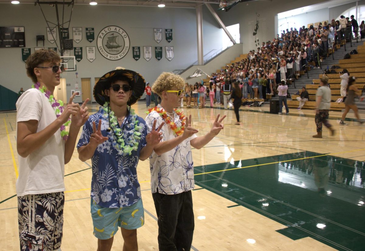 Juniors Justin Fung and Andy Comsa celebrate their victory in Hungry Hippos during the second rally of Palo Alto High School's Spirit Week in the Big Gym during lunch. According to Arabella Guinle, senior spirit commissioner, she likes float building. "My favorite part of spirit week is float building," Guinle said. "It's a chance for me to bond with my classmates and not stress as much. I just love the environment of float building and the awesome food."