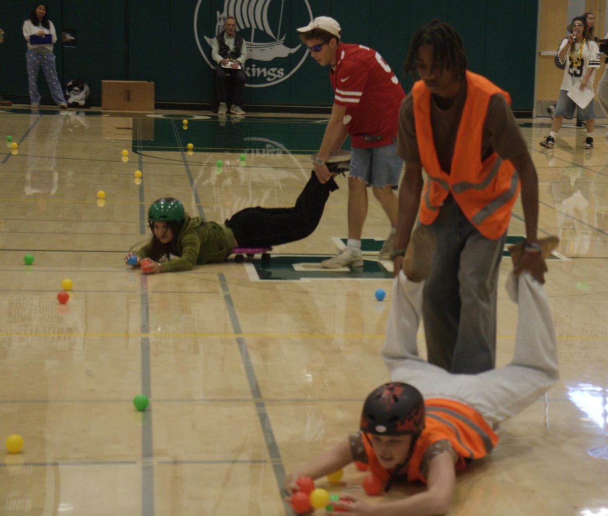 [[can u put this photo through lightroom? or brighten it up somehow? it's really dark]] Seniors and freshmen play hungry hippos in the second rally of Spirit Week [[when and where]]. According to [[put title after name]]senior spirit commissioner Arabella Guinle, she likes float building. "My favorite part of spirit week is float building," Guinle said. "It's a chance for me to bond with my classmates and not stress as much. I just love the environment of float building and the awesome food."