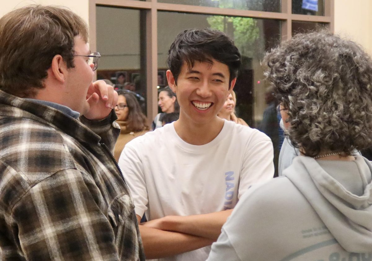 Senior Brendan Giang talks to friends in the in Palo Alto High School's Performance and Arts Center after acting in Paly's theater show the "Crucible" Saturday night. According to Giang, he loves telling stories through multiple mediums. "I really enjoyed telling stories, whether it be acting in plays, making movies or writing," Giang said.