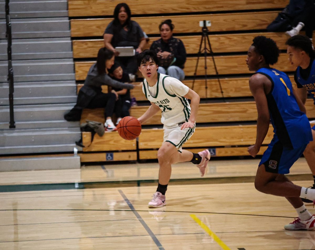 Viking junior Aiden Ong pushes the ball up the court against two defenders during a home game in front of an energetic crowd. According Ong, playing at home provides a valuable boost heading into the season. "It means there’s going to be extra energy and momentum," Ong said. "With a loud home crowd, the opponents will feel the pressure, and our team can use that energy and channel it into the game."