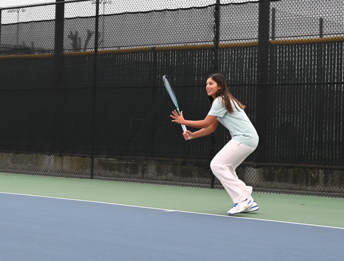 Freshman Akina Ogawa prepares to hit a forehand at the Palo Alto High School tennis courts. According to Ogawa, playing on the Paly tennis team gave her a whole new perspective. “Tennis is an individual sport, and I've never played on a team either, but the atmosphere is just really different,” Ogawa said. “It's really fun to cheer on my other teammates and also see that my teammates are rooting for me.”