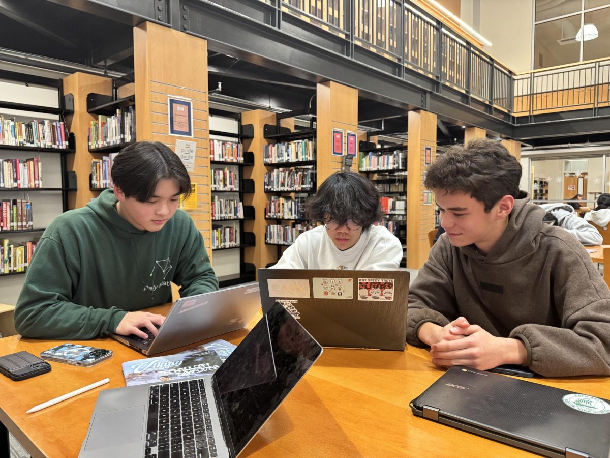 Seniors Connor Lee (Left), Nathan Chen (Middle), and Oliver Payne (Right) study together in the library. According to Payne the library is a space to study and have fun. "I really love the library," Payne said." It gives me a lot of space to connect with my friends study for tests and also relax and play video games."