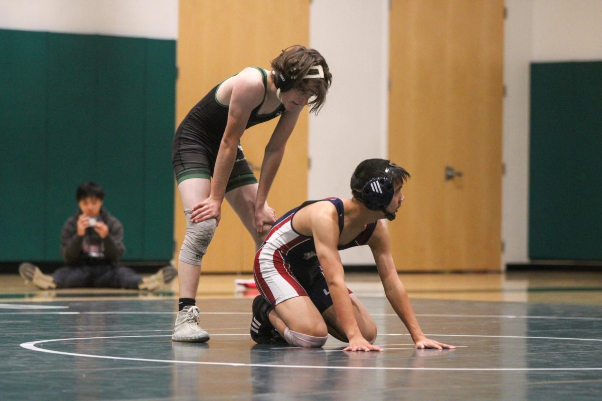 Viking sophomore Reed Hoffman stands over his opponent during the fifth match of the team’s first dual meet of the season on Thursday at home. According to Hoffman, starting the season with a strong performance was a key goal. “It's good I come out at the beginning of the season with a win off the bat, and especially in a dominant way," Hoffman said. "It really sets me up to continue that pace.”